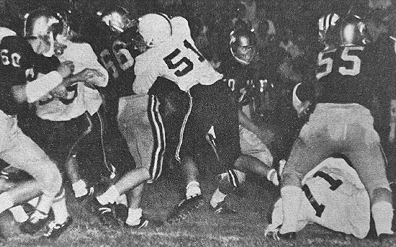 In this photo from the front page of the Sept. 25, 1970 edition of The Graham Star, Ronnie Waldroup (right) begins an eight-yard run in the Smoky Mountain Conference title game against Hayesville, thanks to a hole opened up by offensive linemen Roger Anderson (71) and Barry Millsaps (51).