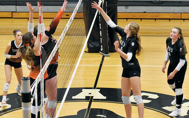 Zaelyn Phillips swats the ball over a pair of Rosman defenders during Tuesday's four-set victory over the Lady Tigers. Photo by Bella Eddings/The Graham Star