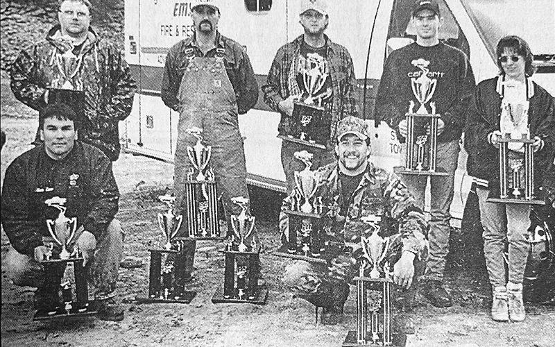In this photo from the Oct. 23, 1997 edition of The  Graham Star, winners of the Stecoah Rescue Squad's "Mud Sling" show off their trophies. Kneeling in front are Alan Lane (left) and Kelly Burnette. Standing in back (from left) are Todd Dooley, Bobby Smith, John Clark, Dusty Ford and Koby Green. Not pictured are Tommy Sumner and Toby Norman.