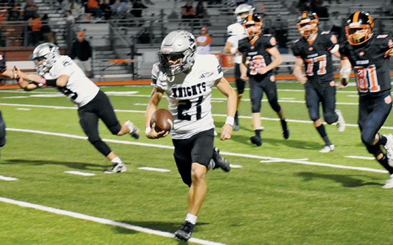 Robbinsville's Eli Lambert leaves an ambush of Tigers in his wake Friday at Rosman. Lambert had a career night, reeling in two scoring receptions and also returning a punt for a touchdown in the Black Knights' rout. Photo by Kevin Hensley/sports@grahamstar.com
