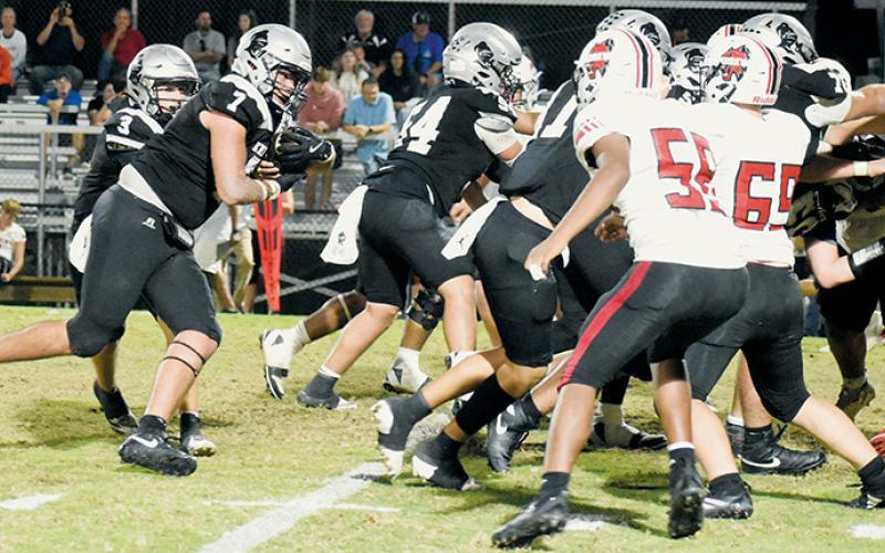 Isiac Collins (7) prepares to enter a scrum during Friday's homecoming game. Collins rushed for 142 yards in Robbinsville's blowout victory over Andrews. Photo by Kevin Hensley/sports@grahamstar.com