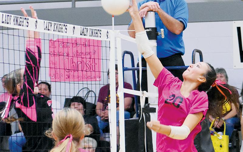 Emory Chekelelee (20) attempts to spike the ball past Cherokee’s Austin Fourkiller-Raby on Monday. Photo by Kevin Hensley/sports@grahamstar.com