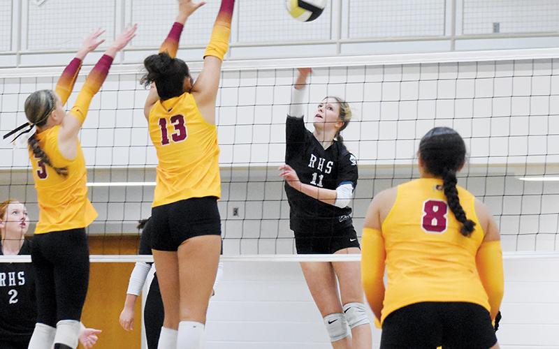 Zaelyn Phillips spikes the ball past the defense of Cherokee’s Austin Fourkiller-Raby (3) and Joscelyn Stamper (13) during Tuesday’s league-tournament semifinal. Photo by Kevin Hensley/sports@grahamstar.com