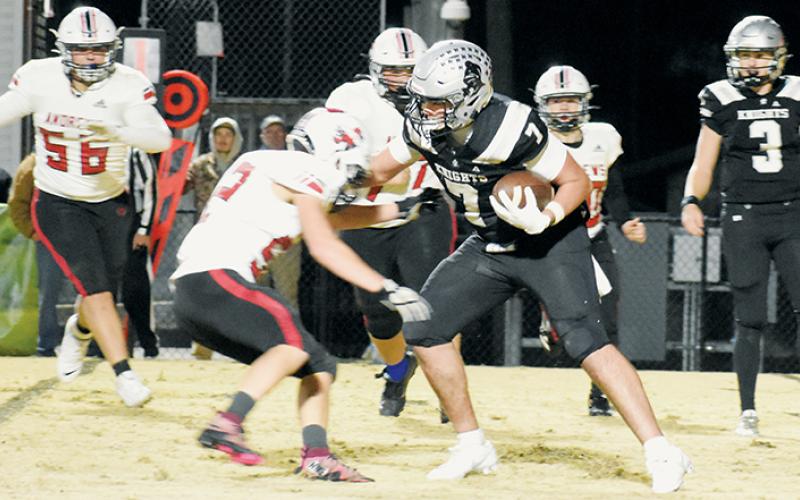 Robbinsville’s Isiac Collins (7) dismisses the defensive effort of Andrews’ Isaac Vaught on a third-quarter rushing attempt during Friday’s second-round playoff game. Photo by Kevin Hensley/sports@grahamstar.com