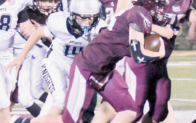 Jax Mullinax (14) closes in on Swain County's Magnus Clark during Saturday's Midgets Cracker Bowl game.