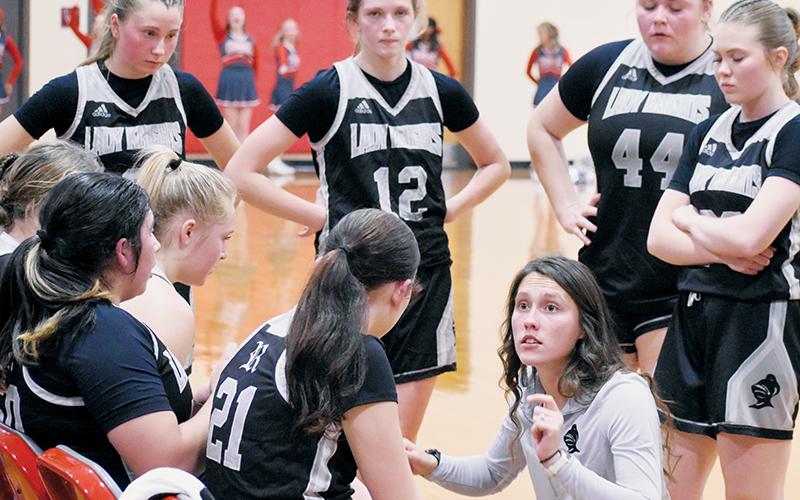 Brooklyn Lester speaks to the Lady Knights during a timeout at Copper Basin on Dec. 1. Robbinsville’s new varsity girls head coach has dove into the role with  purpose, hoping to restore the program as a centerpiece in the community. Photo by Kevin Hensley/sports@grahamstar.com