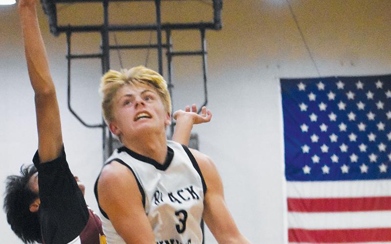 Middle school Black Knight Brayden Allison soars past a Cherokee defender Nov. 17. Allison hit a game-winning lay-up for Robbinsville on Monday at Hayesville. Photo by Kevin Hensley/sports@grahamstar.com