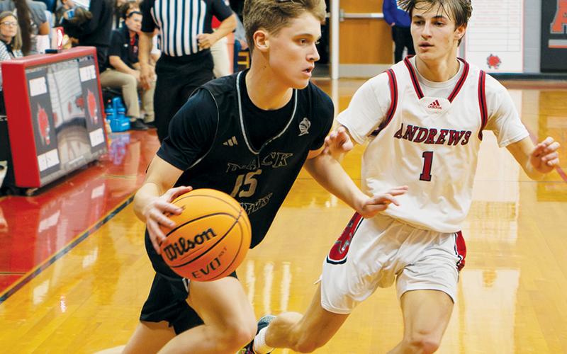 Dane Knott attempts to drive past Andrews’ Gabe Clark during Friday’s conference opener. Knott had a team-best 26 points in Robbinsville’s win over the Wildcats. Photo by Cannon Crompton/Cherokee Scout