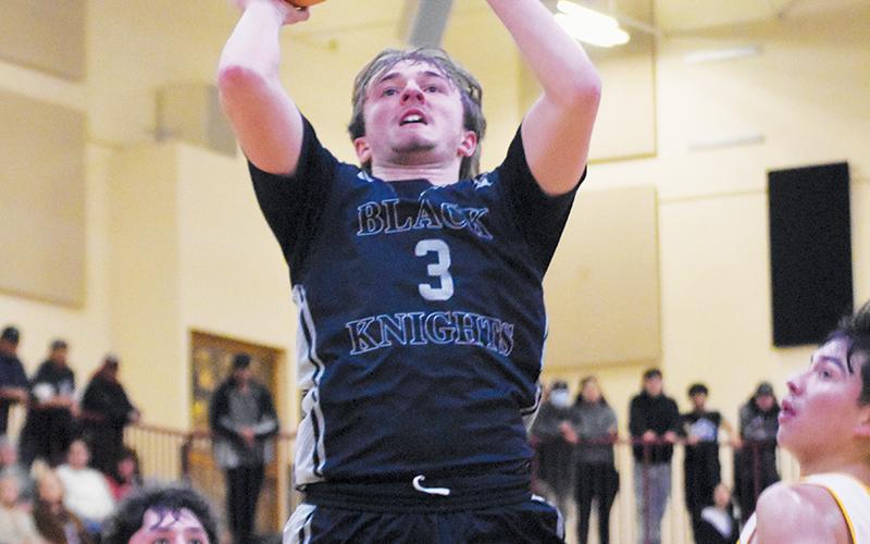 Black Knights point guard Luke Lovin splits a pair of Cherokee defenders, who can only look on in  amazement as the senior glides through the air for a basket attempt during Friday's conference road game. Photo by Kevin Hensley/sports@grahamstar.com