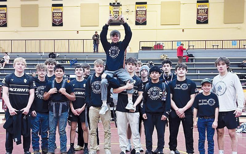 The Robbinsville Black Knights gather with the 2025-26 Smoky Mountain Conference Traditional Tournament championship trophy, which they won Jan. 22 at Cherokee. Photo courtesy of Robbinsville Wrestling