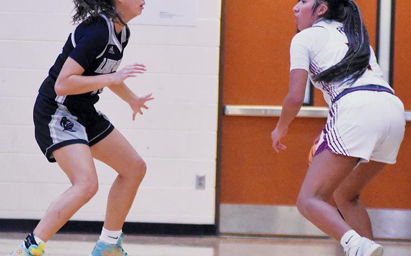 Robbinsville's Aaliyah Wolfe (left) keeps a watchful eye on Cherokee's Dvdaya Swimmer during Friday's conference road game. Photo by Kevin Hensley/sports@grahamstar.com