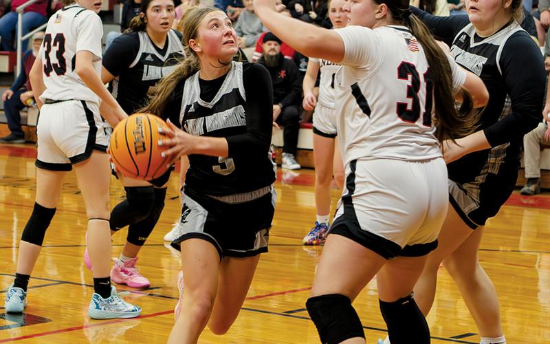 Lady Knights senior Abby Wehr looks to evade the interior defense of Andrews' Alexis Beasley during Friday's clash. The following evening at Smoky Mountain, Wehr delivered a 30-point performance for Robbinsville in a victory over the Mustangs. Photo by Cannon Crompton/Cherokee Scout
