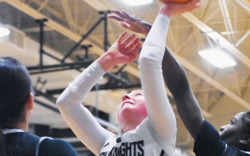 Senior Abby Wehr (3) manuevers past the outstretched hand of Andrews' Juliet Holloway for a first-half basket attempt Tuesday. Photo by Kevin Hensley/sports@grahamstar.com
