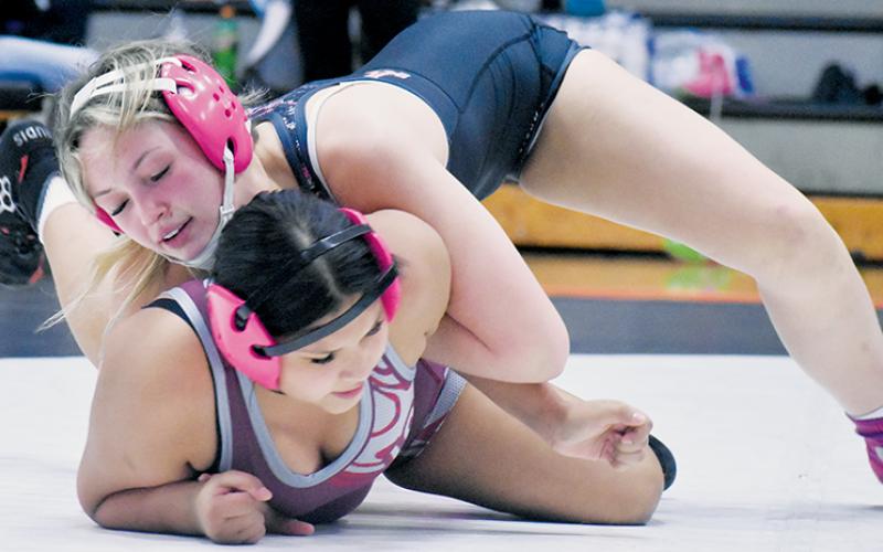 Myah Winfrey – shown grappling with Swain County's Melyssa Wildcatt during Jan. 8's conference-duals tournament – was 1-of-4 Lady Knights to be crowned divisional champion at Jan. 22's traditional competition at Cherokee. Photo courtesy of Bella Eddings/The Graham Star
