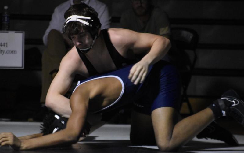 Lleyton Hooper maintains top control on Bonnie Cone Leadership Academy's Malachi Smith during Feb. 10's second-round, dual-team postseason match. Lleyton is 1-of-4 Black Knights that will vie for an individual state championship Saturday in Greensboro. Photo by Kevin Hensley/sports@grahamstar.com