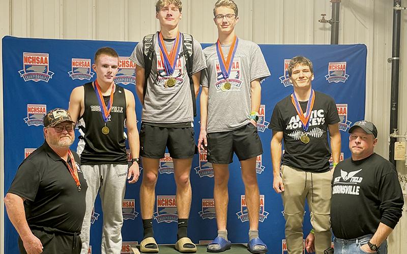 The Robbinsville Black Knights capped a strong showing at Feb. 11's state indoor track meet by winning their third championship of the day in the 4x400 relay. From left are head coach Dale Farr, Austin Bohn, Nathan Frederick, Benjamin Frederick, Colton McCoy and assistant coach Jeremy Lunsford. Photos courtesy of Robbinsville Indoor Track and Field