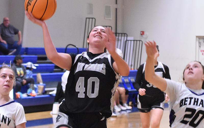 Lady Knights sophomore Bella Coats (40) breaks away from Bethany Community School's Brooke Carter (11) and Ryleigh Wiseburn (20) in the fourth quarter of Thursday's second-round playoff game. More photos can be purchased at geosnapshot.com/grahamstarsports. Photo by Kevin Hensley/sports@grahamstar.com