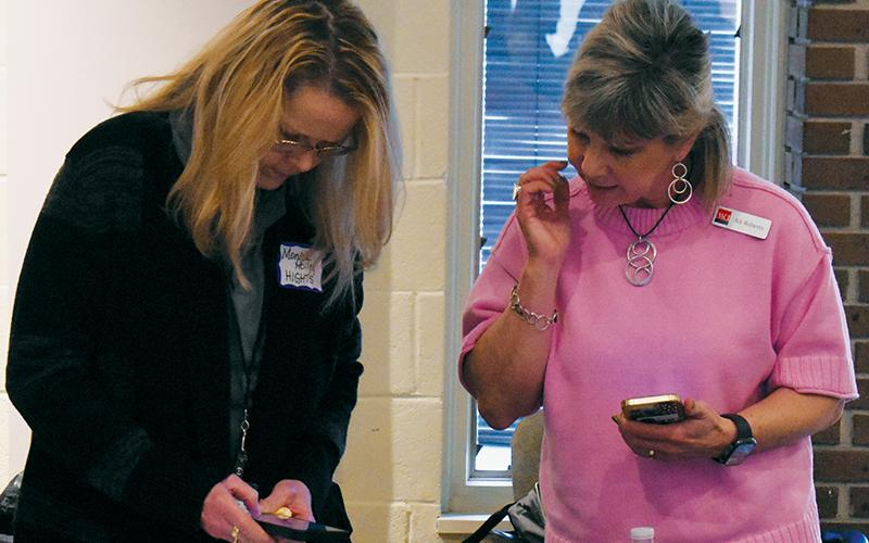 Monica Holley with HIGHTS (left) exchanges contact information with WCI's Kit Roberts during March 12's Graham County Business Roundtable.