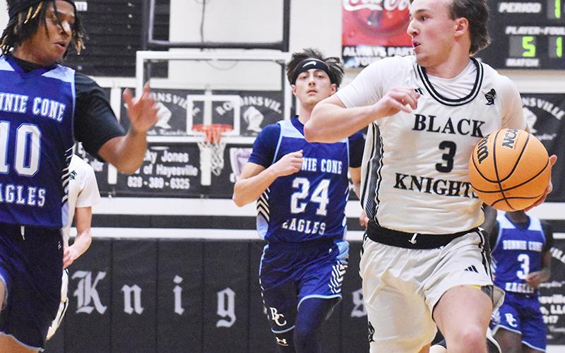 Black Knights senior Luke Lovin (3) keeps a watchful eye on the pursuit of Bonnie Cone Leadership Academy's Jayden Maltre during Thursday's second-round playoff game. Photo by Bella Eddings/The Graham Star