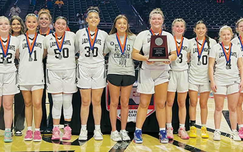 The Robbinsville Lady Knights gather with the 1A state championship runner-up plaque at half-court March 11, after dropping the title game 58-44 to Wilson Preparatory Academy. Photos by Kevin Hensley/sports@grahamstar.com