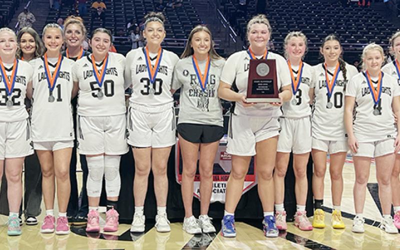 The Robbinsville Lady Knights gather with the 1A state runner-up plaque Wednesday, just minutes after falling 58-44 in the title game to Wilson Preparatory Academy. Photo by Kevin Hensley/sports@grahamstar.com