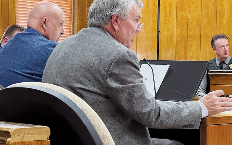 Suspended Graham County Sheriff Brad Hoxit (left) listens intently as defense attorney Stephen Lindsey cross-examines N.C. Department of Insurance Special Agent Jasmine Hanline on Tuesday.
