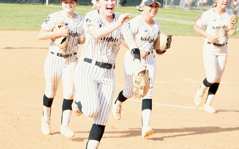 Lady Knights sophomore Daphne Barlow was elated as she sprinted to the dugout after completing the first and second legs of a 6-3 triple play Friday against Swain County. Photo by Kevin Hensley/sports@grahamstar.com