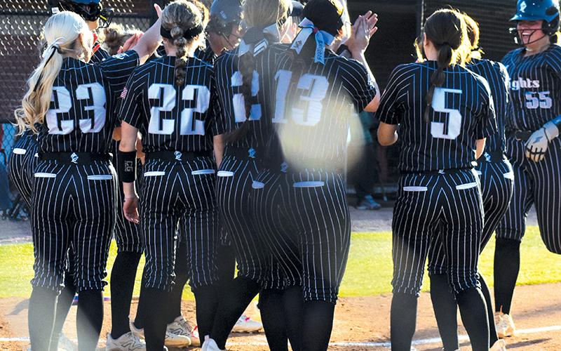 With the rest of the Lady Knights waiting to greet her, Dreylee Webster (55) trots into home plate after hitting her first of two home runs April 9 against A.C. Reynolds. Photo by Bella Eddings/The Graham Star