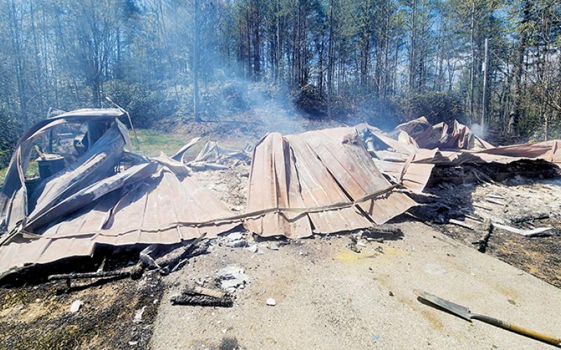 This vacant home at 3744 Santeetlah Road burned Friday, igniting nearby woods and burning two acres of tribal land. Photo courtesy of Tory Lynnes/U.S. Forest Service