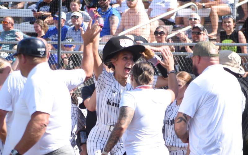 Adorned with the Lady Knights' "Home Run Hat," Robbinsville senior Anna Williams celebrates after hitting a grand slam in the first inning of Friday's state-championship series opener. Williams finished the game with six RBIs. Photo by Kevin Hensley/editor@grahamstar.com