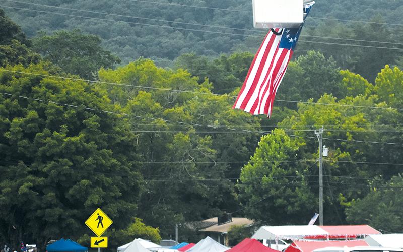 Suspended high above the road, American flags adorned two entrances to the Graham County Heritage Festival. Photo by Lexie Anderson/The Graham Star