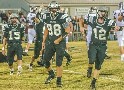 Black Knights Clayson Lane, Rossi Wachacha and Kamron McGuire (from left) were pumped up after Candler Edwards recovered a Swain County fumble during the first quarter of Monday’s 43-6 win over the Maroon Devils. Photos by Byron Housley/The Graham Star