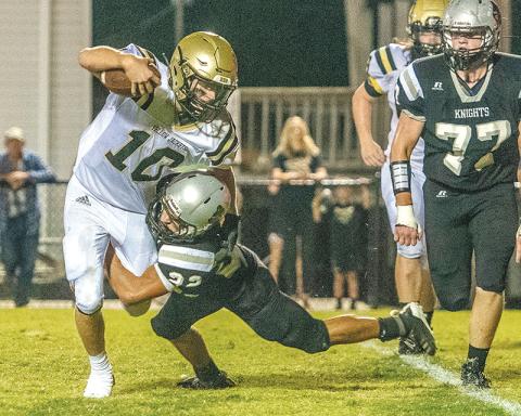 Robbinsville senior Rylee Anderson (22) drops Hayesville quarterback Hayden McClure for a sack during Friday’s 55-10 win over the Yellow Jackets. Photo by Byron Housley/The Graham Star