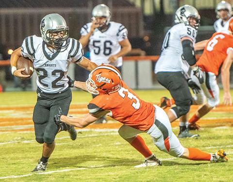 Robbinsville senior Rylee Anderson (22) dashes the hopes of Rosman's Thomas Collins on a big gain Friday. Anderson surpassed the 5,000 career-yards mark during the game. Photo by Byron Housley/The Graham Star