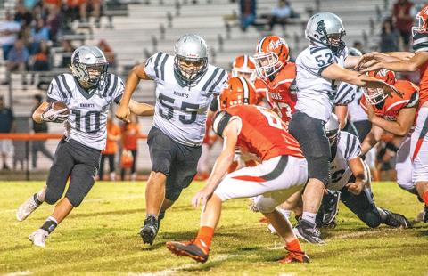 With Xavier Rattler (55) and Stewart Carver (52) clearing a path, Robbinsville’s Wade Hamilton (10) makes his way to the end zone for the final Black Knights touchdown of Friday’s conference opener at Rosman. Photos by Byron Housley/The Graham Star