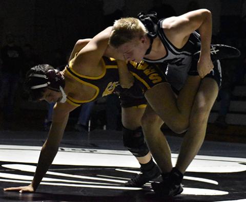 Robbinsville’s Willie Riddle has Cherokee’s John Bradley all tripped up during  Tuesday’s Smoky Mountain Conference opener. Photo by Kevin Hensley/editor@grahamstar.com