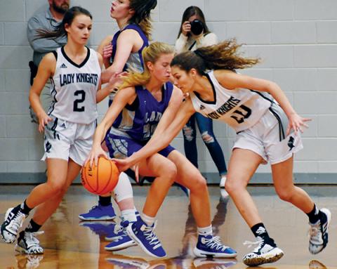 Robbinsville’s Yeika Jimenez (20) swats the ball out of the hands of Smoky Mountain’s Natalie Passis during the Dec. 19 home opener. Photo by Kevin Hensley/editor@grahamstar.com