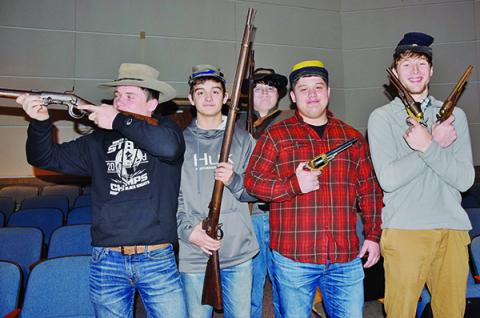Lex Hooper, Wade Hamilton, Samson Jones Candler Edwards and Drey Keener (from left) handle some weaponry, which was part of the Civil War unit at Robbinsville High School on Monday. Photos by Art Miller/amiller@grahamstar.com