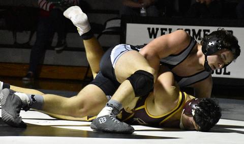 Robbinsville’s Kyle Fink prepares to pin Cherokee’s Ian Crowe during a Dec. 17 home dual against the Braves. Photo by Kevin Hensley/editor@grahamstar.com