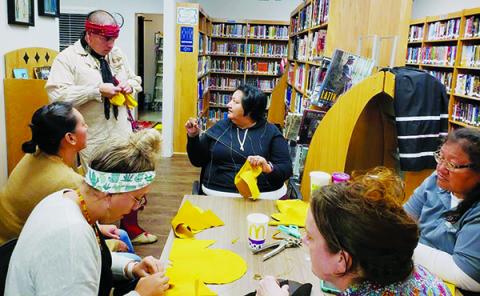 Amateur cordwainers recently gathered at the Snowbird Community Library to make moccasins. Clockwise from top middle are Candy Wachacha-Crowe, Jennifer Wachacha, Robbi Pounds, Kasey Frazier, Paige Wachacha Gross and Michael Crowe. Photo by Art Miller/amiller@grahamstar.com
