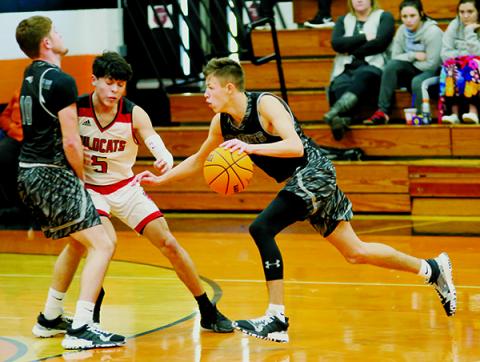 Thanks to Clayson Lane (left) setting a screen on Andrews’ Kabe Ellis, Robbinsville’s Brock Adams finds some open court during Saturday’s Smoky Mountain Conference quarterfinal tournament game against the Wildcats.