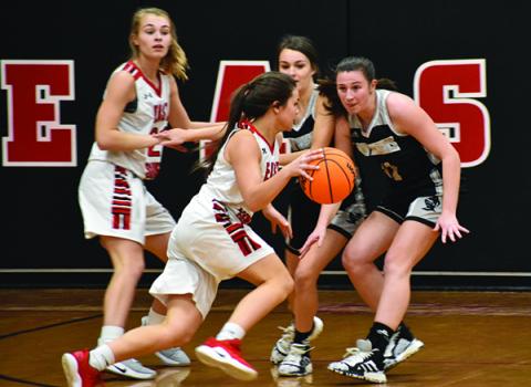 Robbinsville seniors Cambrie Lovin (left) and Karlyn Matheson eye an East Surry player during Thursday's game in Pilot Mountain. Photo by Kevin Hensley/editor@grahamstar.com