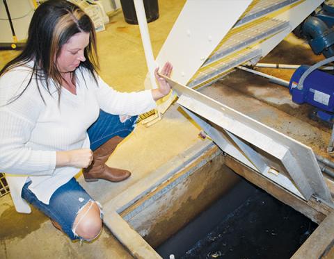 Water Treatment Facility Operator Carrie Stewart  examines the finished water at the Rock Creek  Treatment Plant on Monday. At this point, the water has  already went through several treatments and filters before being pumped into the main tank for distribution across Robbinsville. Photos by Art Miller/amiller@grahamstar.com