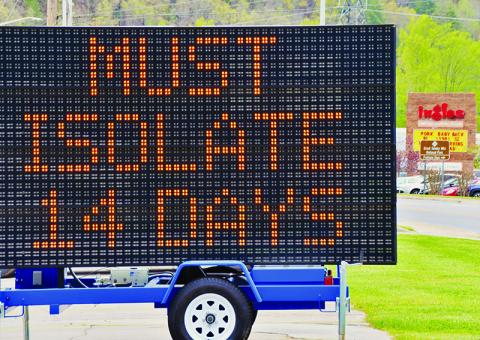 This electronic sign sits in the Quality Inn parking lot and greets visitors as they enter Robbinsville, providing instructions on protocol should visitors wish to stay in Graham County. The sign is 1-of-3 placed throughout the county and was approved by the Graham County Emergency Management Coordination Committee during its teleconference Wednesday, April 22. Photo by Art Miller/amiller@grahamstar.com