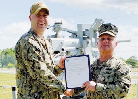 Navy veteran and Graham County resident Jason Marino (right) was recently  promoted to Master Chief. Presenting Marino with his Frocking Letter is Commander Henderson.