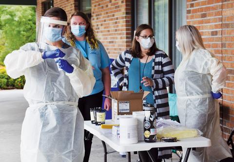 Those wishing to be tested for COVID-19 were able to stop outside the Robbinsville Post Office on Wednesday, Aug. 19. On-hand to help conduct the tests were Hannah Anderson, April Morefield, Emily Collins and Haley Anderson (from left). Photo by Art Miller/amiller@grahamstar.com