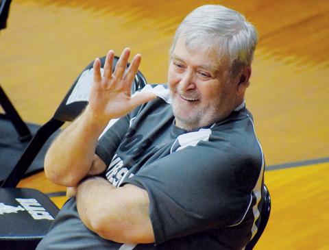 Right at home while sitting at the edge of the mat, George Oliver waves to spectators before the start of a Robbinsville match. The co-founder of the Black Knights’ wrestling program passed away Aug. 5. Photos by Jenny Millsaps/The Graham Star