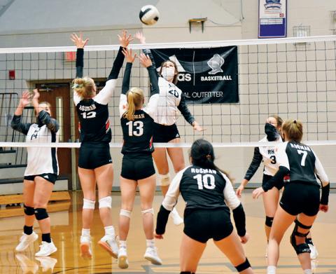 Lady Knights junior Yeika Jimenez (20) closes in on a kill attempt during Monday’s season opener against Rosman. Note athletes on both sides wearing masks, thanks to a recent mandate handed down by the N.C. High School Athletic Association. Photos by Kevin Hensley/editor@grahamstar.com