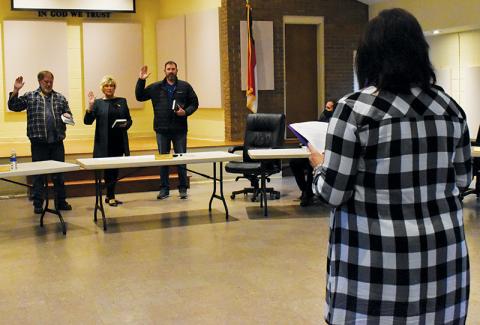 Graham County Clerk of Court Tammy Holloway swears in re-elected Board of  Commissioners’ members (from left): Keith Eller, vice-chairman; Connie Orr,  chairman; and Jacob Nelms. Photo by Charlie Benton/news@grahamstar.com
