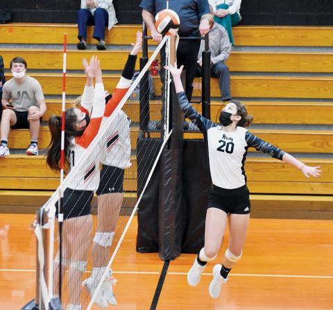 Yeika Jimenez launches for a hit past a pair of Rosman defenders during Tuesday’s road conference match. Photos by Kevin Hensley/editor@grahamstar.com